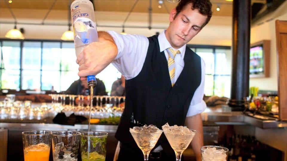 Hotel Bartender Mixing Alcoholic Drinks